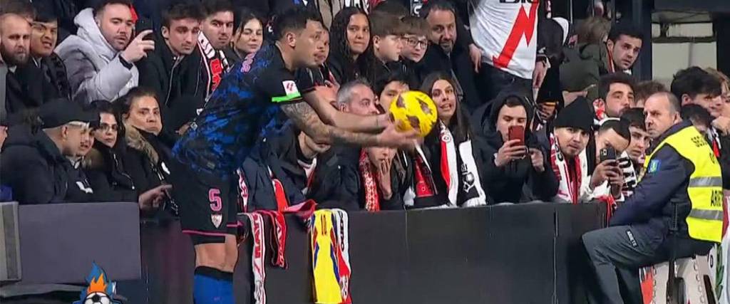 Este es el momento donde un aficionado toca la parte trasera del jugador del Sevilla en pleno partido.