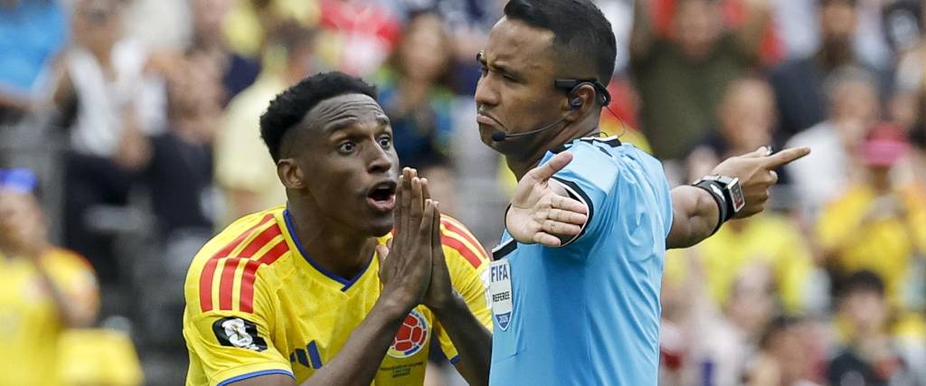 El árbitro salvadoreño Iván Barton recibe el reclamo del colombiano Jhon Lucumí.