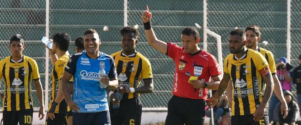 Gery Vargas, árbitro orureño, le muestra la tarjeta roja al defensor de Blooming, Julio Vila. 